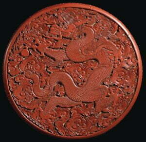 A cinnabar lacquer ‘dragon’ box, Yongle mark and period, with over carved Xuande mark, 23.5cm diameter.
